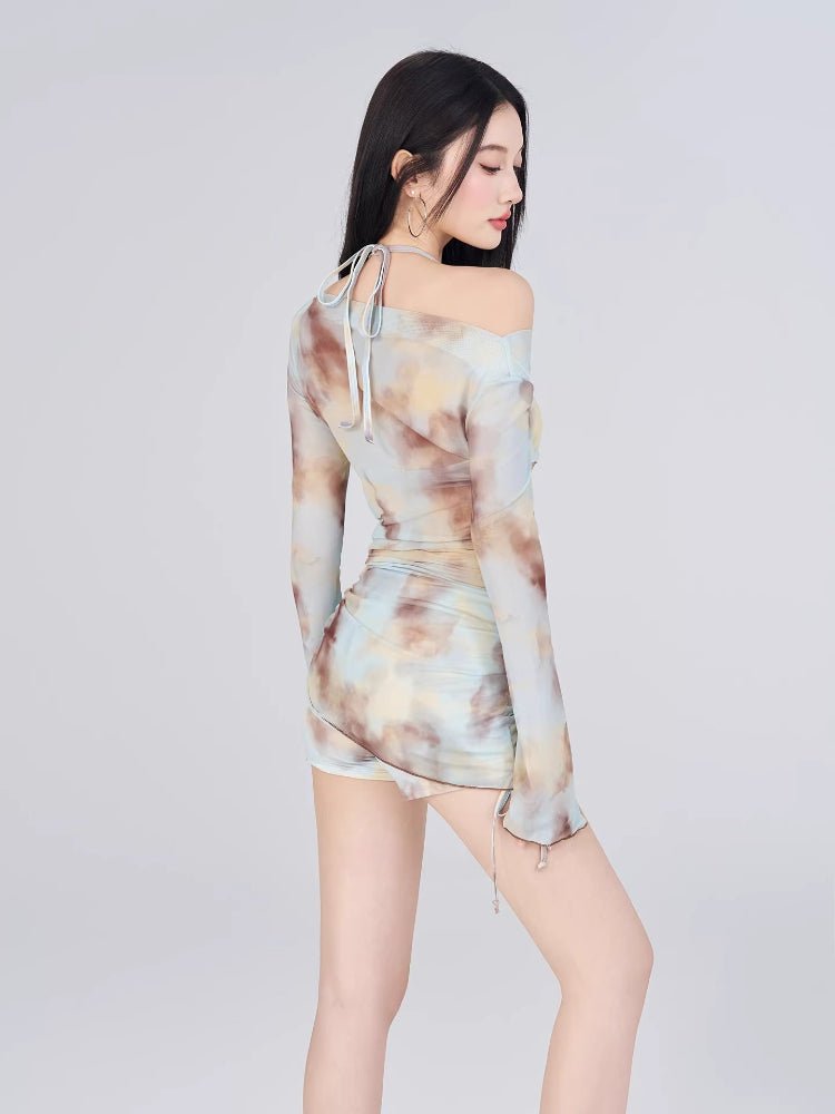 Back view of a woman wearing a tie-dye print mesh overlay top and shorts