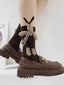 A person wearing brown knee-high ribbed socks with a plush bunny applique and brown chunky sole loafers.