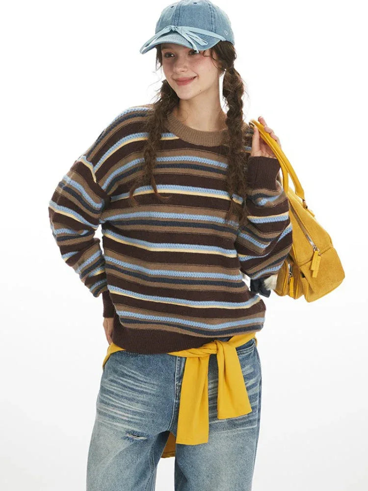 Close-up of the model's face and upper body, showing the striped sweater and yellow bag.