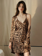 Woman wearing a leopard print satin cami slip dress and matching robe.