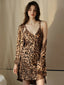 Woman wearing a leopard print satin cami slip dress and matching robe.