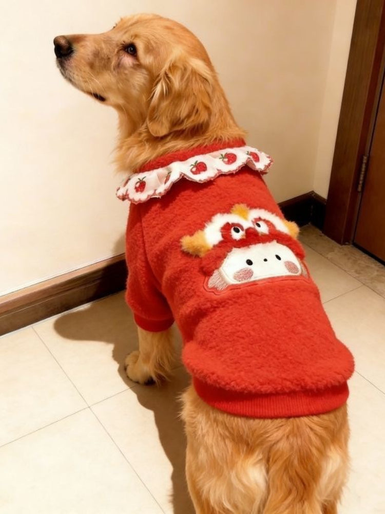 Side view of a golden retriever dog in a red fleece sweater