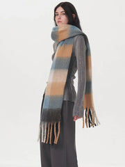 Model wearing a grey sweater and plaid scarf