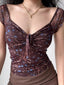 Close-up of a brown floral print mesh top with a sweetheart neckline and tie detail