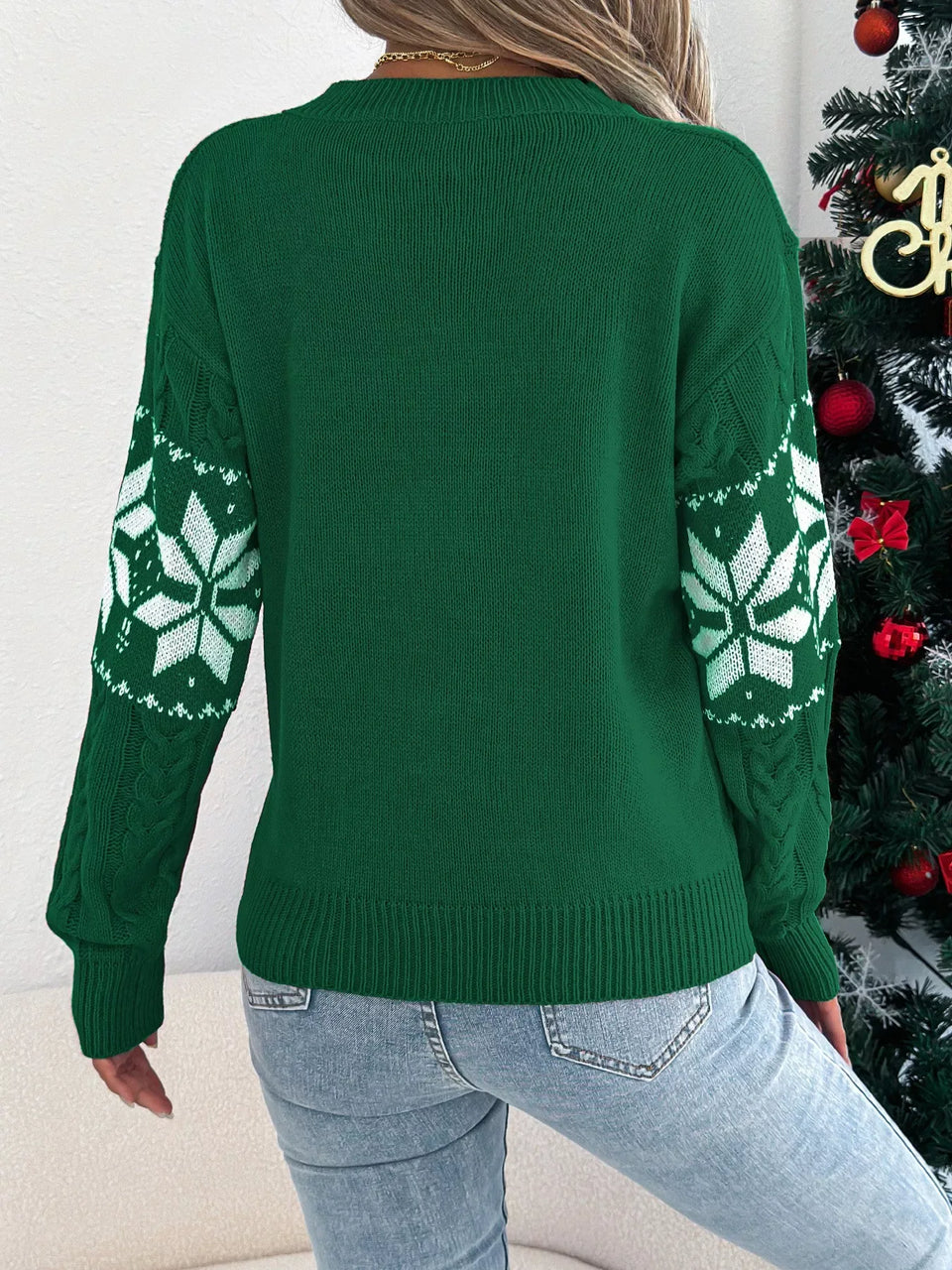back view of woman wearing green snowflake print knit sweater Secondary image