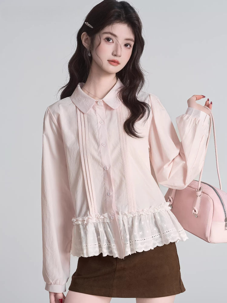 Woman wearing a light pink ruffled peplum blouse with a Peter Pan collar and lace trim, holding a pink handbag.
