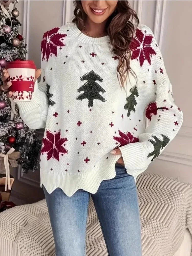 Woman wearing a white knitted sweater with a Christmas tree and snowflake print, holding a red and white coffee cup.