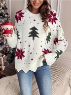 Woman wearing a white knitted sweater with a Christmas tree and snowflake print, holding a red and white coffee cup.