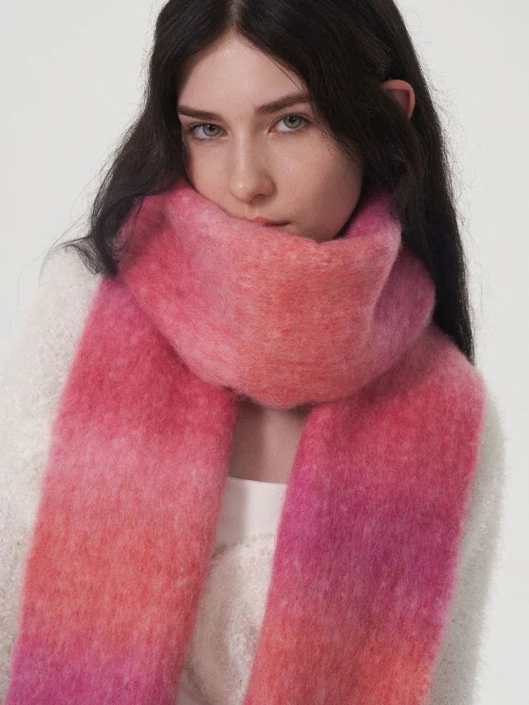 Close-up of a woman wearing a pink and orange gradient scarf.