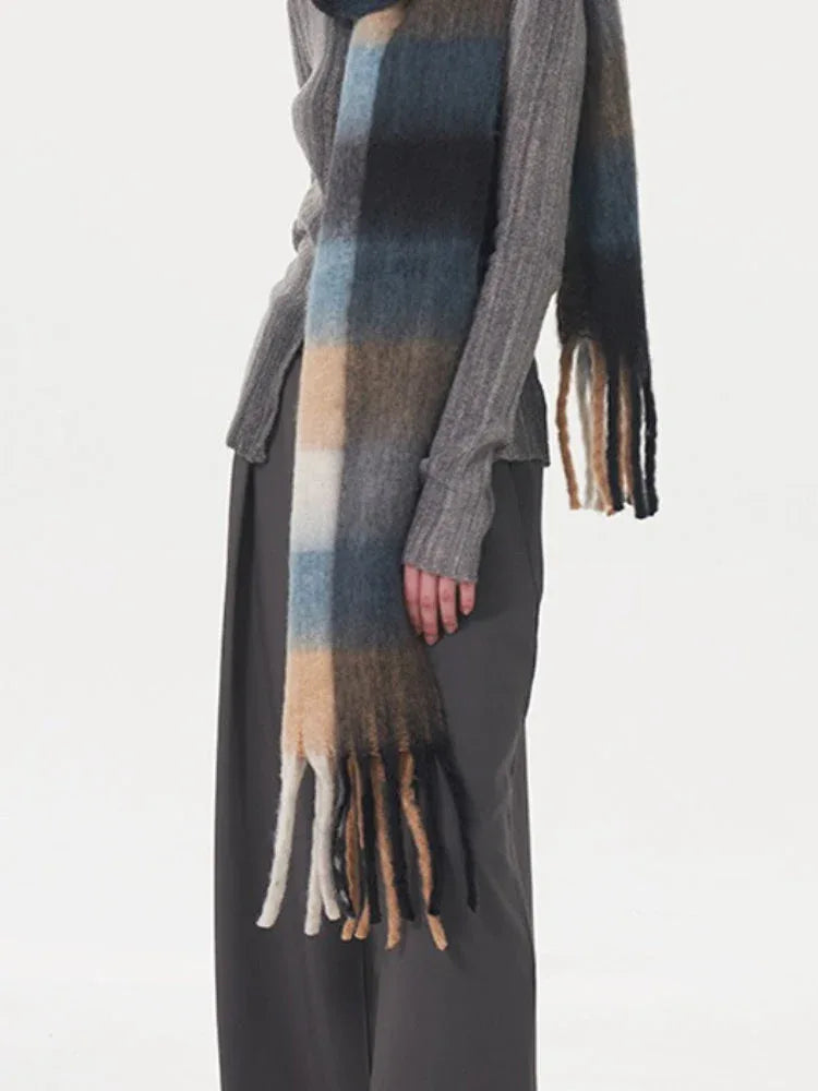 Close-up of a model's hand and scarf