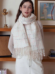 Close-up of a woman wearing a white plaid scarf with fringe