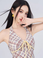 Close-up of a woman wearing a plaid halter dress