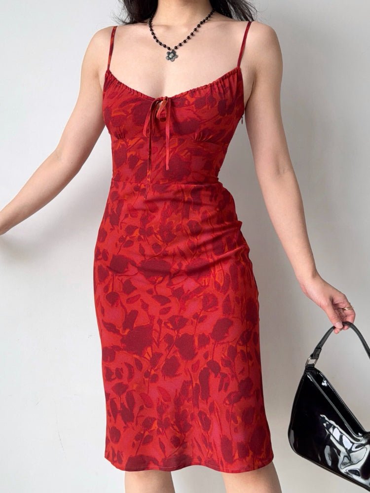 Front close-up of the red floral print midi dress highlighting the neckline and tie detail.