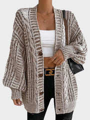 Close-up of the front of a brown and white striped oversized knit cardigan
