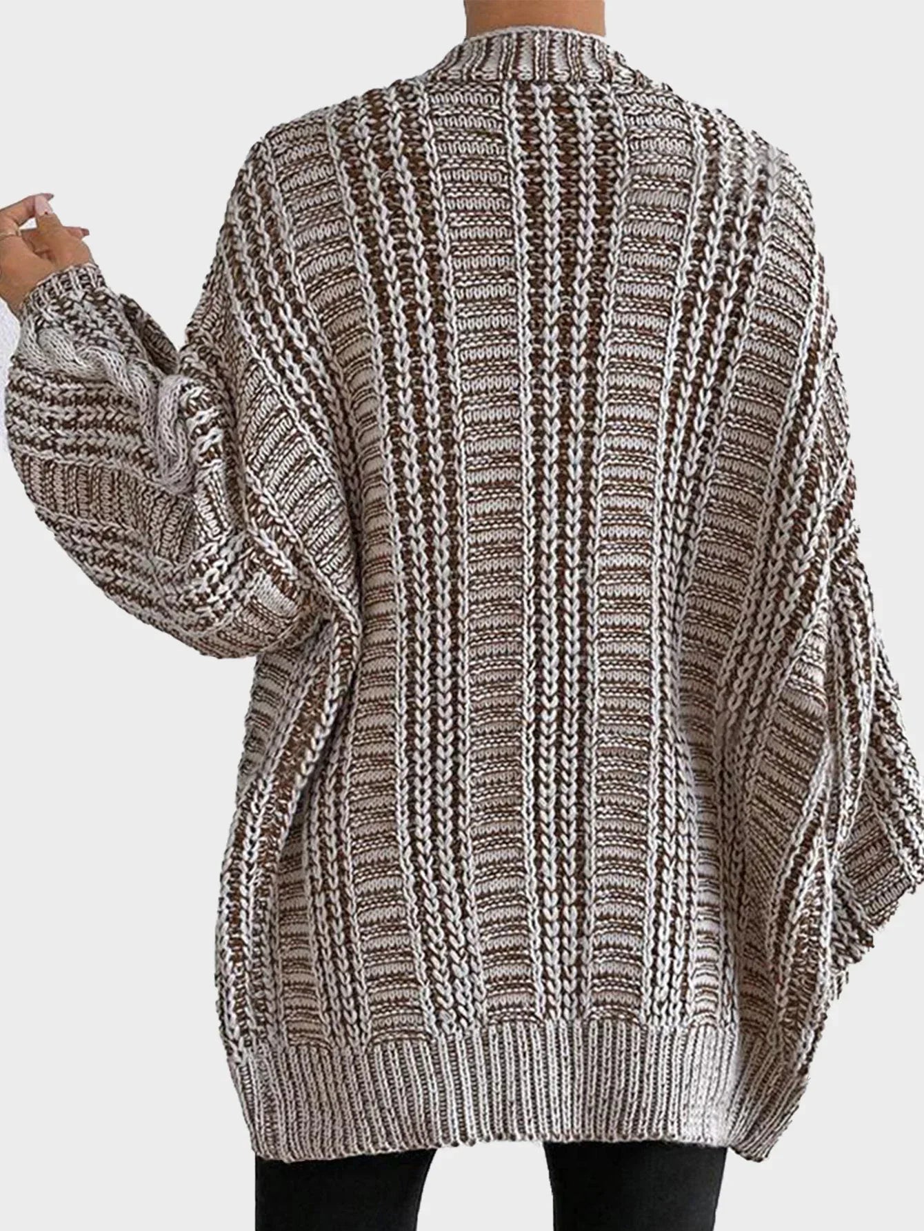 Back view of a woman in a brown and white striped oversized knit cardigan
