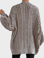 Back view of a woman in a brown and white striped oversized knit cardigan