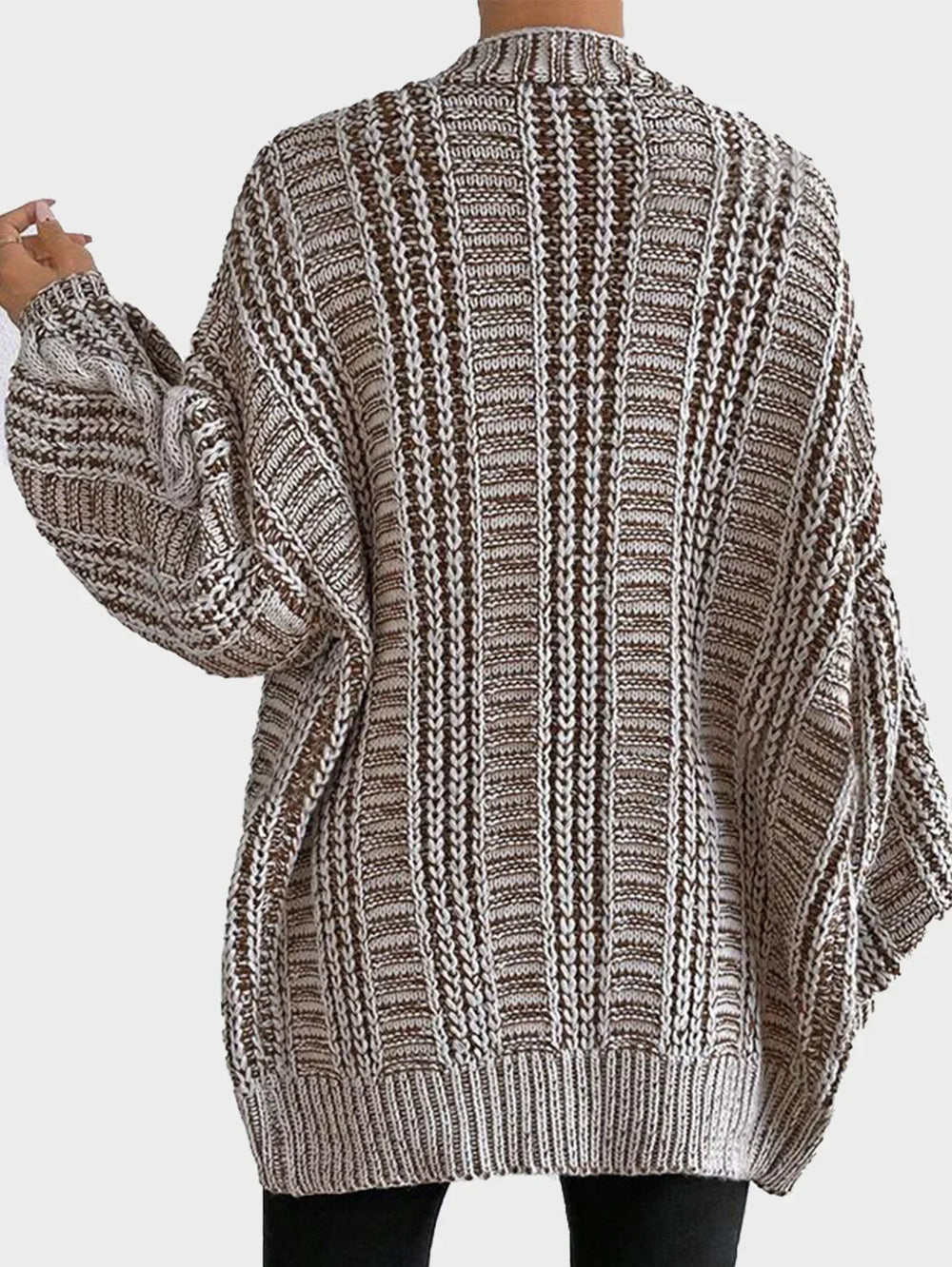 Back view of a woman in a brown and white striped oversized knit cardigan