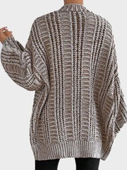 Back view of a woman in a brown and white striped oversized knit cardigan