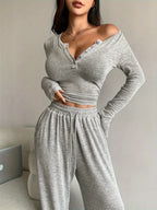 woman wearing a grey knit loungewear set with a long sleeve v-neck top and wide leg pants