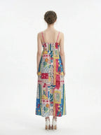 Woman wearing a colorful printed maxi dress with spaghetti straps, back view