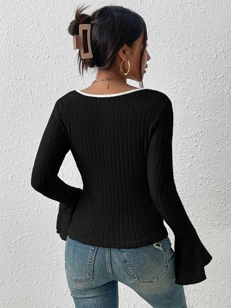 Back view of a black ribbed long-sleeve top with a white trim square neckline and flared bell sleeves, paired with blue jeans.