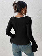 Back view of a black ribbed long-sleeve top with a white trim square neckline and flared bell sleeves, paired with blue jeans.