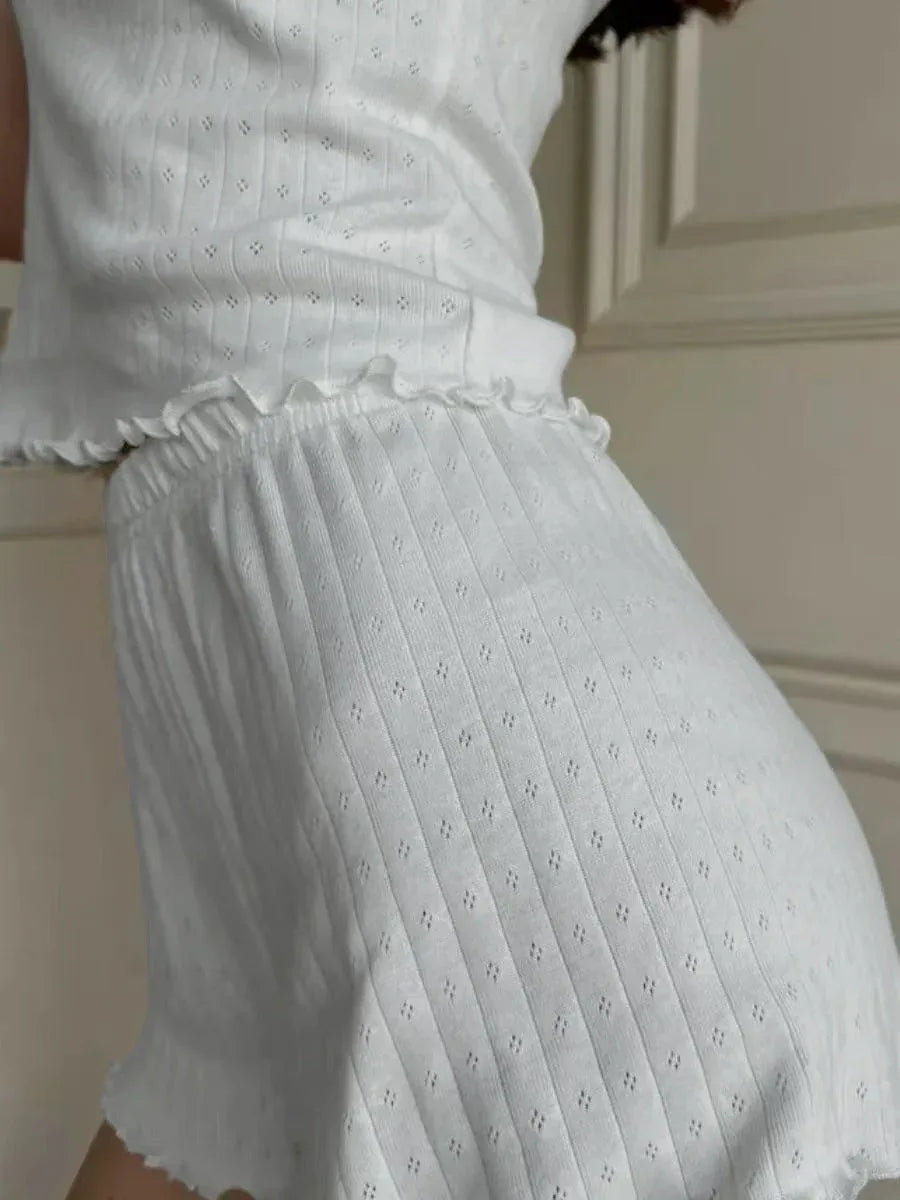 Close-up of the scalloped waistband and ribbed texture of the shorts.