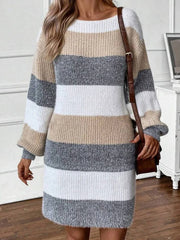 Front view of a woman in a striped knit dress, accessorized with a brown crossbody bag.