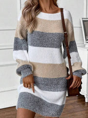 Woman wearing a long-sleeved, striped knit dress with a brown crossbody bag.