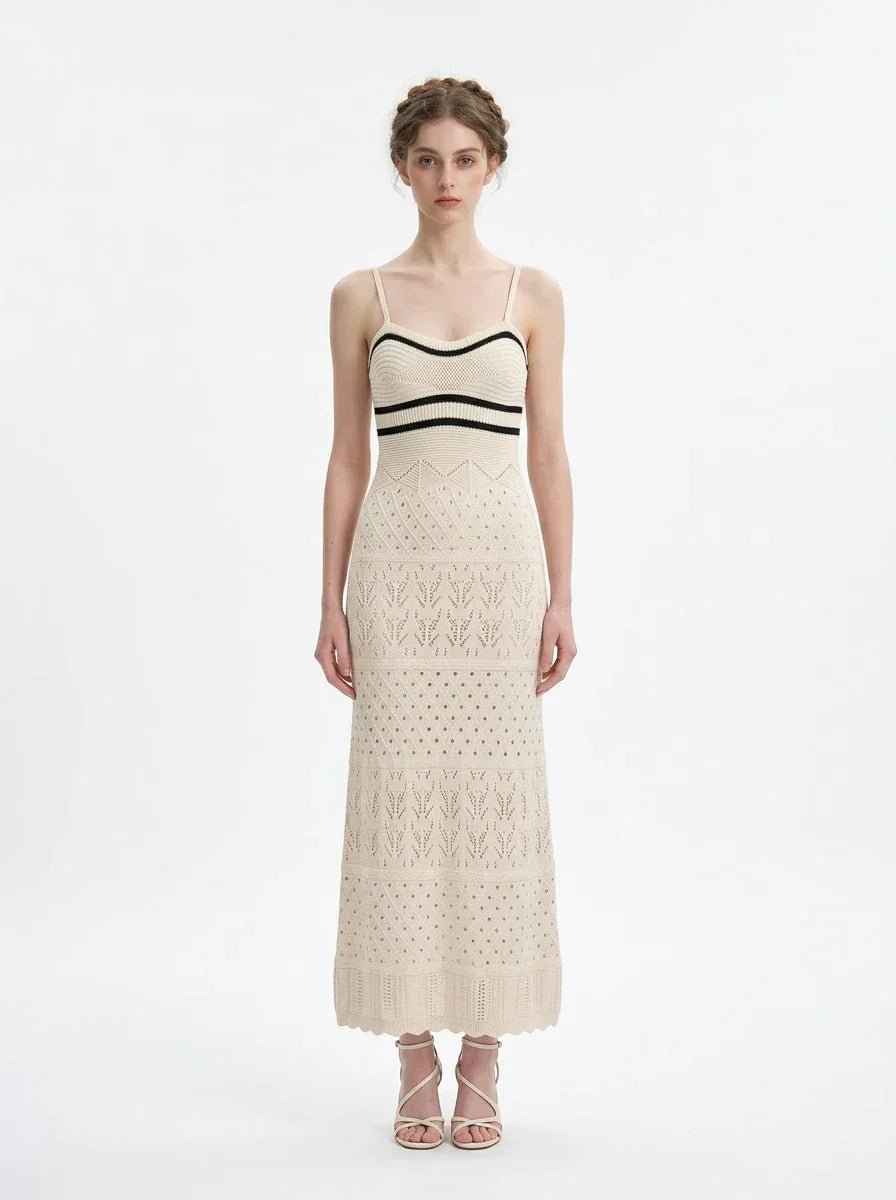 Woman wearing a cream knit maxi dress with black stripes on the bust, shown front view on a white background.