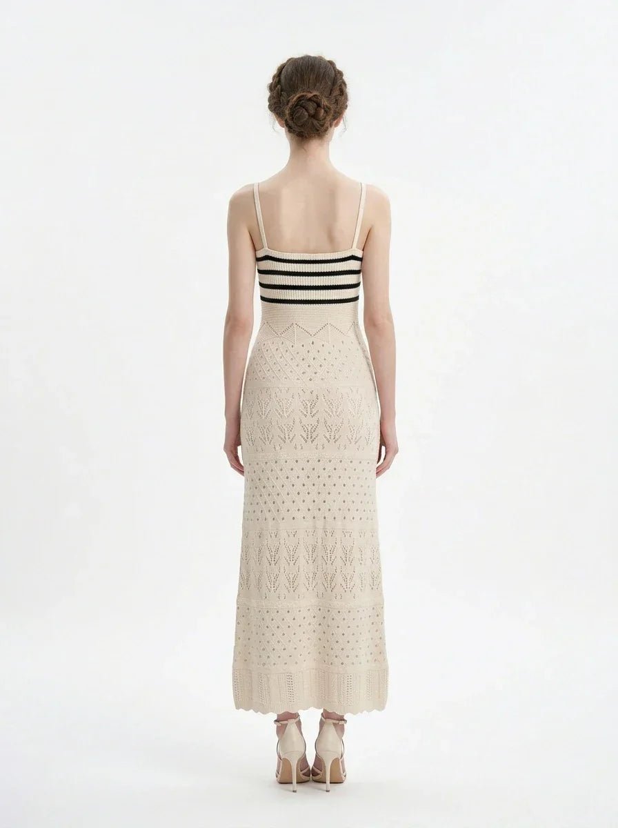 Woman wearing a cream knit maxi dress with black stripes on the bust, shown back view on a white background.