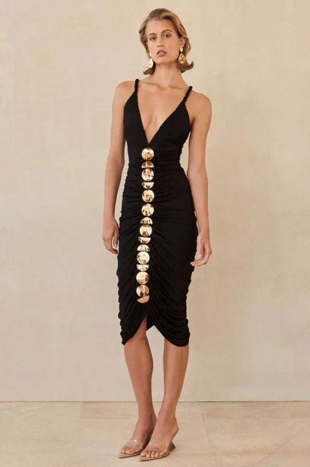 Full-length view of a woman in a black ruched midi dress with gold embellishments. Secondary image
