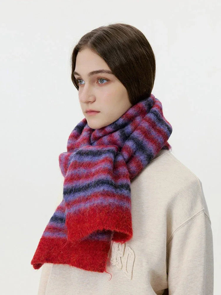 Side profile of a woman wearing a red and purple striped fuzzy scarf