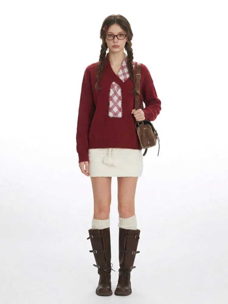 Woman wearing a burgundy v-neck sweater with a white plaid detail, a white textured mini skirt, white knee-high socks, and brown buckled boots, carrying a brown crossbody bag. Main image