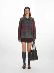Model wearing a grey plaid knit jacket with a brown mini skirt and grey knee-high socks.