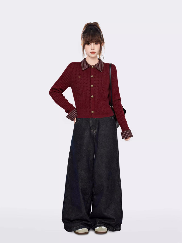 Full body shot of a woman in a burgundy cable knit cropped cardigan and wide-leg jeans.