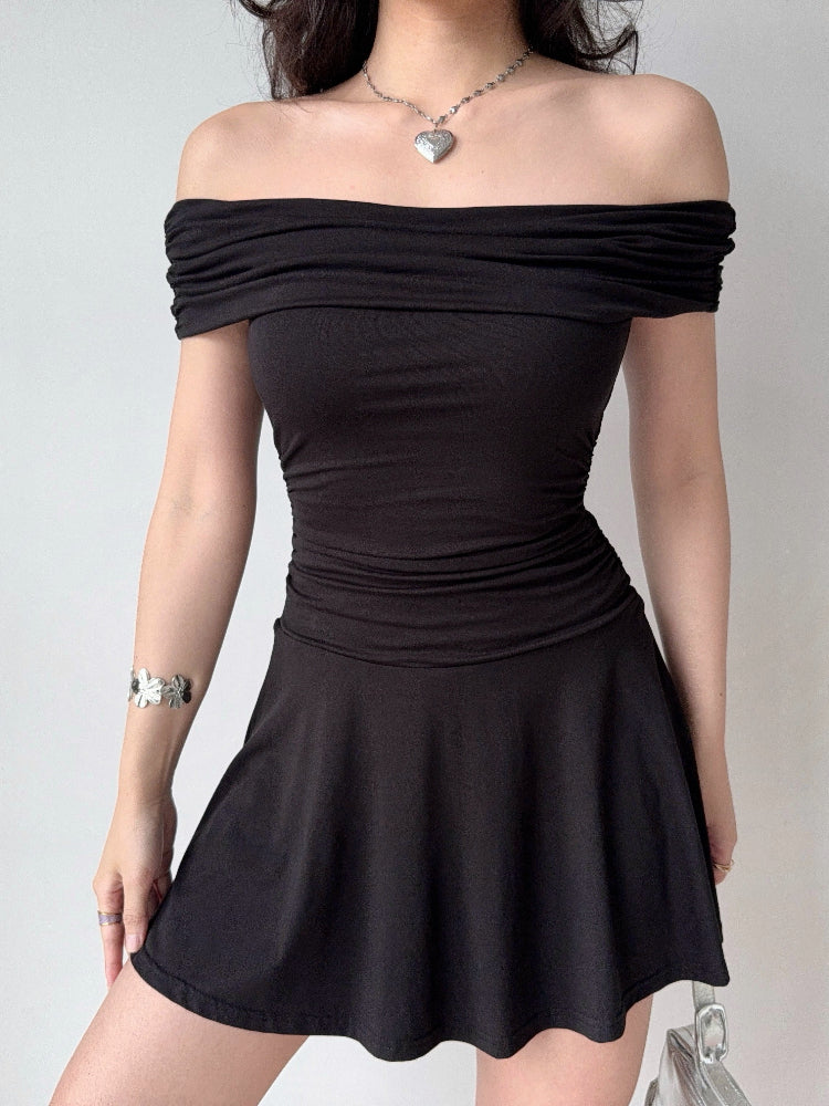 Model wearing a black off-the-shoulder knit dress with a flared skirt.