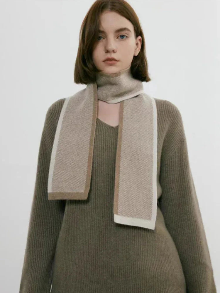 Woman in a taupe v-neck sweater and matching skirt with a scarf