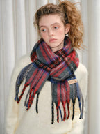 Close-up of a red, blue, and gray tartan plaid scarf with fringes.