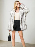 Woman in a white and gray faux fur coat, cream tank top, and black shorts, holding a black handbag
