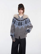 Close-up of a woman wearing a grey and blue Fair Isle knit zip-up cardigan with a faux fur trim hood