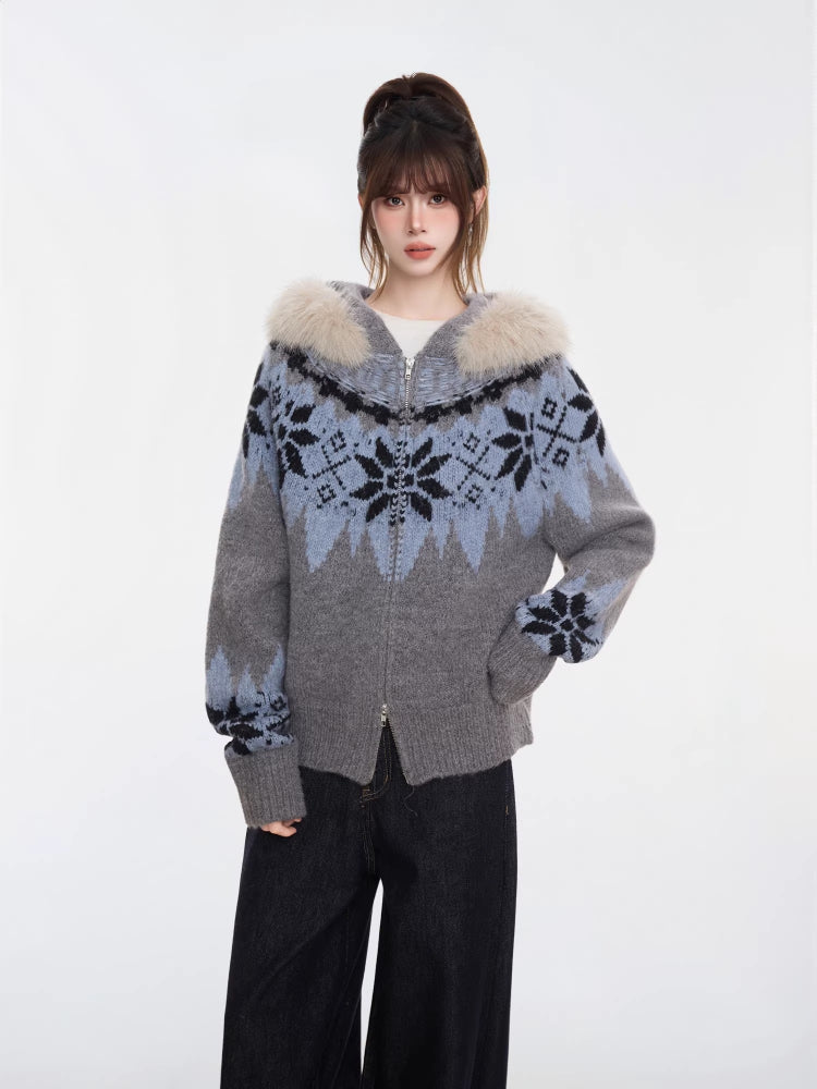 Close-up of a woman wearing a grey and blue Fair Isle knit zip-up cardigan with a faux fur trim hood