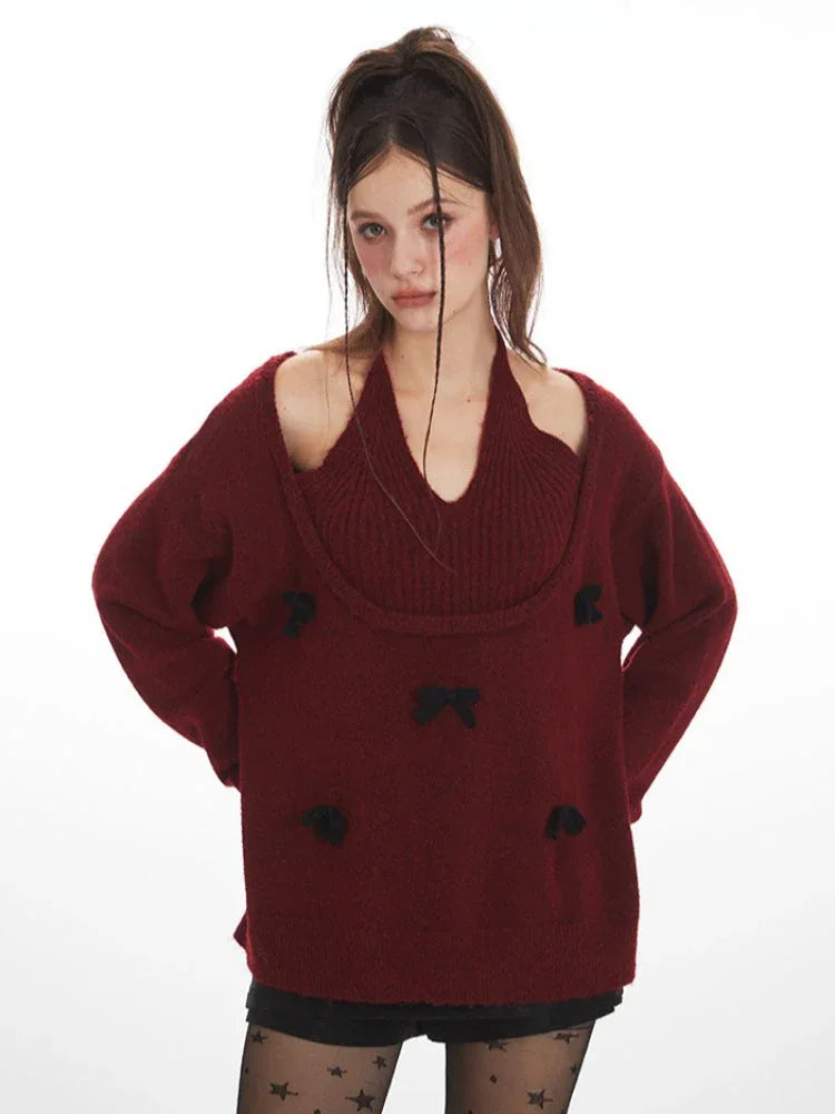 Close-up of a woman wearing a burgundy layered sweater with black bows, black star-patterned tights, and black boots, holding a black handbag.