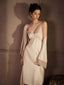 Woman wearing a cream satin slip dress with lace trim and a matching robe, standing with arms at her sides.