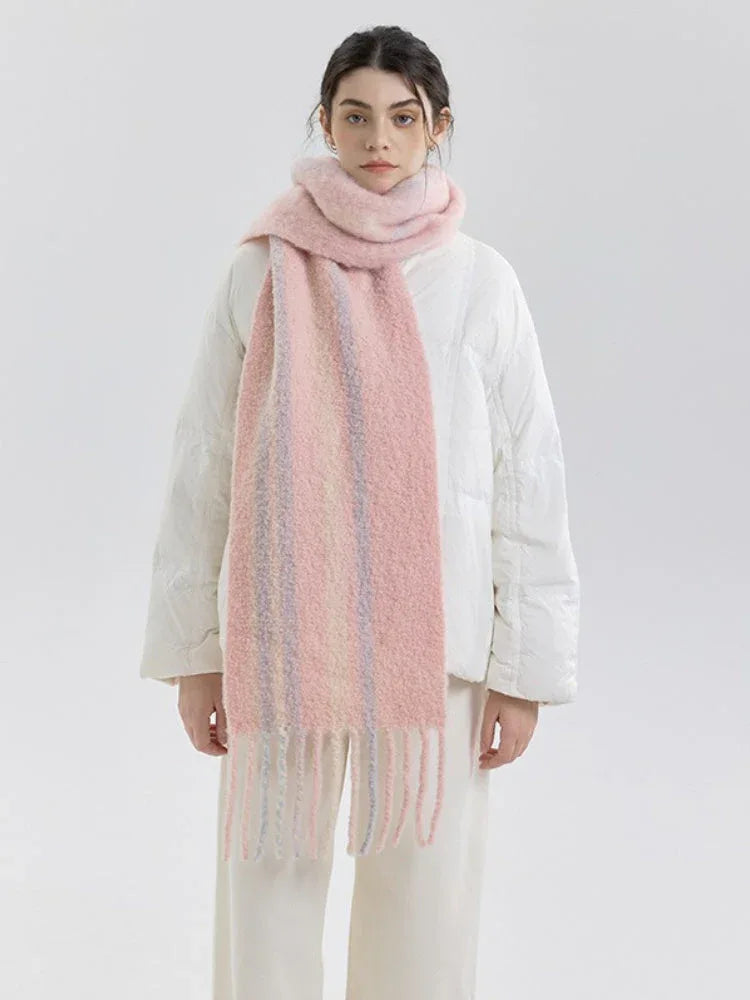 Woman wearing a pink and purple striped scarf with fringe detail over a white puffer jacket