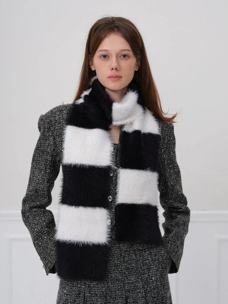 Woman posing with a black and white checkered faux fur scarf
