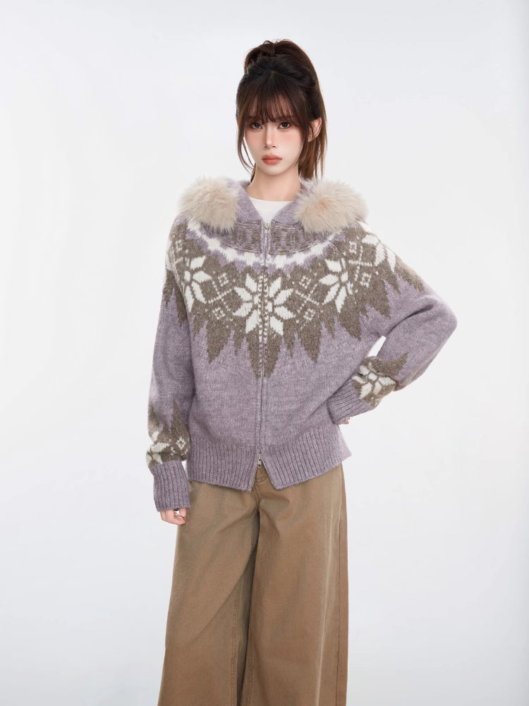Woman wearing a purple and white Fair Isle knit zip-up cardigan with a faux fur trim hood and tan wide-leg pants