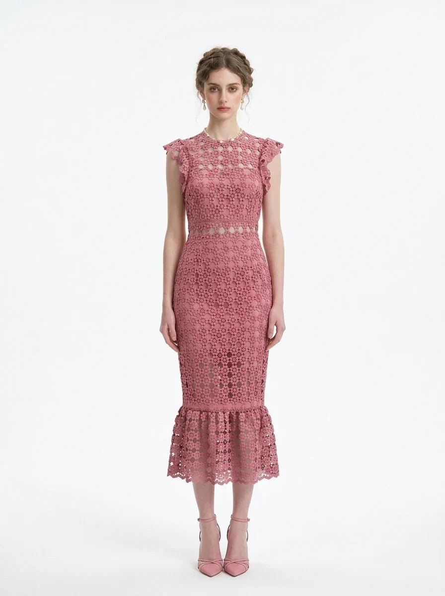 Woman wearing a pink lace dress with ruffled cap sleeves and a mermaid hemline, front view.