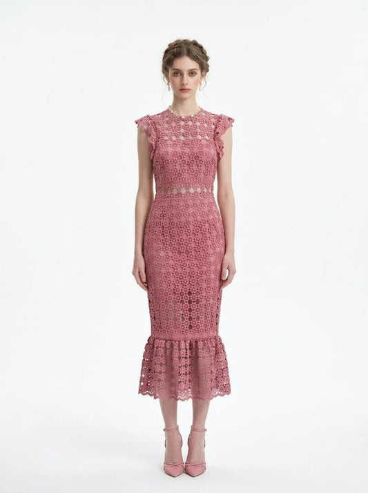 Woman wearing a pink lace dress with ruffled cap sleeves and a mermaid hemline, front view.