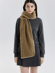 Woman facing forward wearing a brown fuzzy knit scarf and dark grey sweater